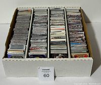 Box filled with assorted hockey cards arranged upright in four rows separated by dividers.