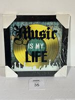 Front view of the Music Is Life wall hanger showing the design and packaging