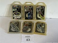 Photo showing all six NASCAR-themed keychains in original poly blister pack packaging, laid out in two rows of three.