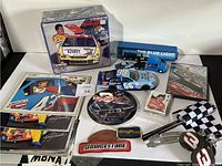 Overall lot with sealed model kit, diecast cars, trading cards, patches, flags, and DVDs