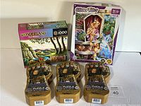 Display of five new puzzles including Wonderland 1000-piece, Glitter Tales 100-piece, and three Marvel Infinity Gauntlet shaped puzzles.