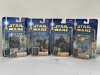 Front view of three Star Wars figures in sealed packaging from 2002 Hasbro Attack of the Clones and The Phantom Menace series.
