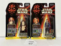 Two unopened Hasbro 1998 Star Wars Episode I CommTech figures in packaging featuring Qui-Gon Jinn and Padmé Naberrie, displayed side by side.
