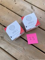 Two Rogers Ignite WiFi Pod boxes pictured on wooden surface with pink number 23 card.
