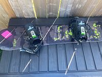 Top-down view of the snowboard showing the length and attached bindings with pixelated graphics.