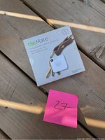 Front view of Tile Mate Bluetooth tracker in original packaging showing attached key ring and product branding.