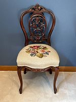 Full view of chair showing carved mahogany frame and upholstered seat