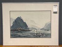 Framed watercolor seascape showing boats, mountains, and signature on the front.