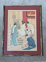 Framed vintage Japanese ukiyo-e print showing full view of the framed artwork with bamboo style frame and maroon matting.