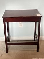 Front view of the vintage walnut side table showing rectangular top, legs, and stretcher base