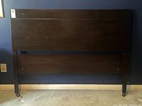 Front view of walnut headboard and side rails with small scratch visible