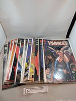 Twelve Vampirella comics edition 0 to 11 stacked in protective sleeves showing edges and partial front covers.