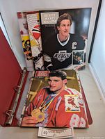 Photo showing Beckett Hockey Monthly magazine with Wayne Gretzky on cover and another magazine inside a binder sleeve.