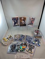 Full lot of assorted hockey cards including numbered, rookie, and jersey patch cards displayed on a table.