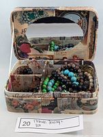 Photo of jewelry box open showing beaded stretch bracelets inside and heart-shaped mirror on lid