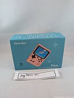 Blue retail box of the Game Box Plus handheld console with image of the console and product name