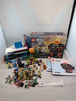 Full lot overview showing Lego ice cream truck, minifigures, loose pieces, and BrickHeadz box
