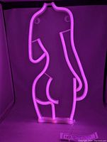 Pink LED Lady Body Neon Sign glowing pink in dark background.