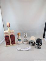 Full lot photo showing all six salt and pepper shakers including Coca-Cola vending machines, Jetsons characters, and VW Bus designs.