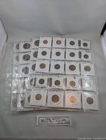 Full lot of vintage collectible coins displayed in plastic sleeves with labeled coin flips.