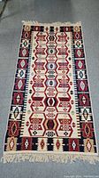 Full view of the hand knotted Turkish rug showing overall pattern and fringe details.