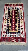 Full view of hand knotted Turkish rug laid flat showing overall pattern and fringes