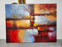 Front view of large oil on canvas abstract painting with vibrant warm and cool colors and textured brush strokes.
