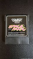 Front view of Space Panic video game cartridge with ColecoVision label and game title.