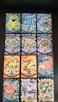 12 Topps Pokemon cards from 1999 featuring Pokemon #71-82 with holographic foil backgrounds, laid out on black backgrounds showing shiny reflective surfaces and artwork of various Pokemon.