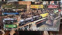 Full boxed set showing the assembled train on a track in front of detailed background, labeled 'THE INSIDER'S EXPRESS'.