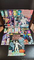 Overview of 11 Silver Surfer comics arranged with some standing and others stacked, showing various cover art and Marvel branding from late 1980s.