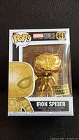 Front view of sealed Funko Pop Iron Spider Man figure with gold chrome finish, number 440.