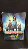 Front view of the sealed Pandemic board game box showing characters and game title.