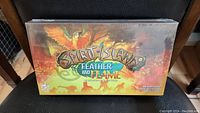 Front view of the sealed Spirit Island Feather and Flame expansion box showing title and colorful cover art.