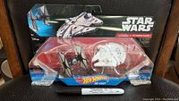 Front view of sealed Hot Wheels Star Wars TIE Fighter vs. Millennium Falcon set showing ships in clear plastic packing.