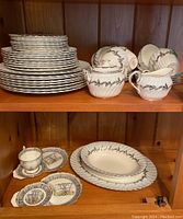 Stacked Foley Silver Fern dinnerware including plates, cream, sugar bowl, serving platter and bowl with Royal Albert Silver Birch tea and biscuit plates.