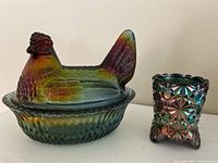 Boyd glass iridescent chicken candy dish with ribbed base next to Degenhart iridescent toothpick holder.