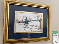 Framed winter landscape print by M Findlay with double matting and gold frame.