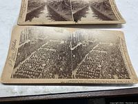 Stereoview card showing a parade at Chicago World's Fair with crowds and buildings