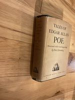 Photo of the spine and front cover of the book showing the title and illustrator.