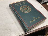 Front cover of the vintage hardcover book 'Twenty Thousand Leagues Under the Sea' by Jules Verne, showing title and author name with decorative elements.