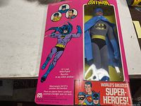 Front of box showing figure in window, branding and text