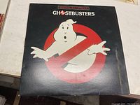 Front cover of the Ghostbusters original soundtrack vinyl record showing the iconic Ghostbusters logo (white ghost and red no symbol).