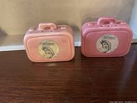 Two ceramic salt and pepper shakers shaped like suitcases with Dartmouth Nova Scotia decals.