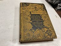 Front hardcover with intricate gold and black embossed floral designs and text including 'Paxton Edition' and a literary quote.