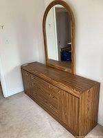 Full dresser with drawers and doors shown against the wall
