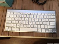 Top-down view of Apple wireless keyboard showing full key layout and overall condition.