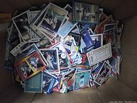 Top view of a box filled with assorted vintage baseball collector cards.