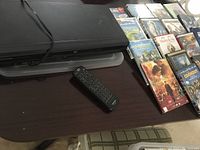 Toshiba black DVD player with remote on top, several DVDs arranged beside the player.