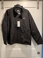 Front view of men's black front zip jacket with "Master" embroidery and tag attached